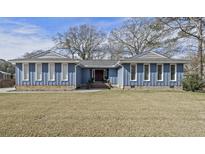 Charming single-story home with a blue exterior, lush green lawn, and inviting curb appeal at 809 O'Sullivan Drive, Mount Pleasant, SC 29464