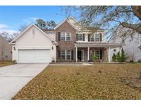 Charming two-story brick and siding home with a covered front porch and attached two car garage at 9616 N Carousel Cir, Summerville, SC 29485