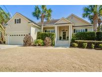 Charming single-Gathering home featuring a two-car garage, manicured landscaping, and a welcoming front porch at 1284 Palmetto Peninsula Dr, Mount Pleasant, SC 29464