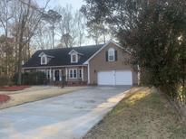 Charming home featuring a well-manicured lawn, dormer windows and a two-car garage at 132 Hidden Fawn Cir, Goose Creek, SC 29445