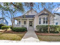 Charming home featuring a covered front porch, well-maintained landscaping, and inviting curb appeal at 145 Cartright St, Charleston, SC 29492