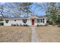 Charming one-story home featuring a red front door and a well-manicured lawn at 17 Anita Dr, Charleston, SC 29407