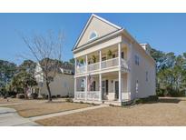 Charming two-story home with a double porch, white columns, and manicured landscaping at 1945 Hubbell Dr, Mount Pleasant, SC 29466