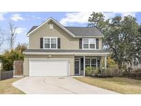 Charming two-story home with a well-maintained lawn, attached garage, and inviting curb appeal at 2005 Nitsa St, Johns Island, SC 29455