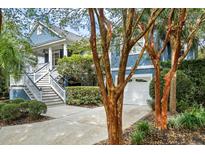 Charming two-story home with a white staircase and a view of the attached garage and landscaped yard at 2664 Magnolia Woods Dr, Mount Pleasant, SC 29464