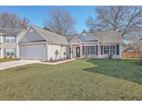 Charming single-story home featuring a well-manicured lawn, garage, and inviting front entrance at 2740 Four Winds Pl, Mount Pleasant, SC 29466