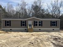 Charming one-story home with tan siding, black shutters, and a neatly maintained front yard, awaiting landscaping at 286 Marion Rd, Dorchester, SC 29437