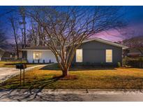 Charming renovated home featuring a well-manicured front yard and a mix of modern and traditional design elements at 600 Piedmont Ln, Ladson, SC 29456