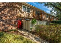 Charming townhome with brick and wood exterior and a vibrant red front door at 607 Saint Charles Ct, Charleston, SC 29407