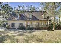 Charming two-story home with a inviting front porch and a well-maintained lawn and established landscaping at 1042 Chambers Ln, Mount Pleasant, SC 29464