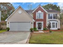 Charming two-story home with a well-maintained lawn, brick and vinyl siding, and an attached two-car garage at 105 Carter Dr, Goose Creek, SC 29445