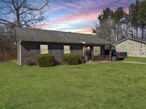 Charming brick home with a well-manicured lawn and a cozy front porch at 115 O'Carroll St, Moncks Corner, SC 29461