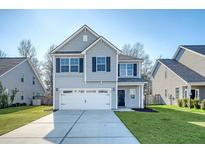 Charming two-story home featuring a two-car garage, well-maintained lawn, and attractive gray siding at 1305 Discovery Dr, Ladson, SC 29456