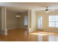 Bright living room featuring hardwood floors, elegant columns, and abundant natural light at 1310 Basildon Rd # 1310, Mount Pleasant, SC 29466