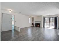 Bright living room boasts fireplace, balcony access, and stylish gray flooring at 1714 Greystone Blvd # 47, Mount Pleasant, SC 29464