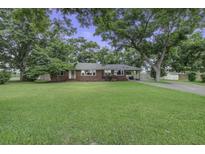 Charming brick home featuring a lush lawn and mature shade trees at 1758 Mendel Rivers Rd, Saint Stephen, SC 29479