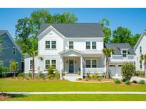 Charming two-story white home with a well-manicured lawn, landscaped yard, and inviting front porch at 1796 Bolden Dr, Mount Pleasant, SC 29466