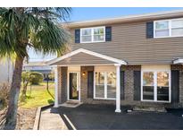 Charming two-story home with brick and siding, featuring a covered entrance and well-maintained landscaping at 1860 Mepkin Rd # H1, Charleston, SC 29407