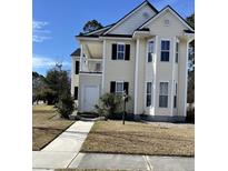 Charming two-story home boasts a welcoming front porch, classic black shutters, and a well-maintained lawn at 1861 Hubbell Dr, Mount Pleasant, SC 29466
