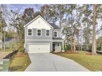 Charming two-story home with a well-manicured lawn and attached two-car garage at 2021 Quiet Ibis Rd, Hanahan, SC 29410