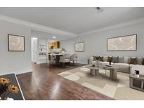 Inviting living room featuring modern decor, hardwood floors, and an open concept design at 402 Andrea Ln, Hanahan, SC 29410