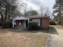 Charming single-story brick home with a well-maintained front yard and classic curb appeal at 4451 Donwood Dr, Ladson, SC 29456