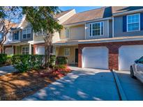 Charming townhome features an attached garage, mature landscaping, and a well-maintained exterior at 546 Tayrn Dr, Charleston, SC 29492