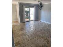 Bright dining room featuring tile floors, sliding glass doors and elegant chandelier at 604 Ventura Pl, Mount Pleasant, SC 29464
