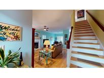 Bright living room featuring an open floor plan, hardwood floors, and stairs to the second floor at 936 Provincial Cir, Mount Pleasant, SC 29464