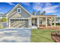 Charming home with a two-car garage, inviting front porch, and well-maintained landscaping at 1028 Island Preserve Rd, Johns Island, SC 29455