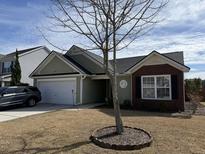 Charming single-Gathering home featuring a two-car garage, brick facade, and well-maintained front yard at 109 Charlesfort Way, Moncks Corner, SC 29461
