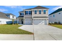 Charming two-story home with attached two-car garage and well-manicured front lawn at 132 Grange Cir, Summerville, SC 29486