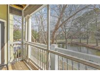 Relaxing screened balcony view of the neighborhood pond and landscape at 1321 Telfair Way, Charleston, SC 29412