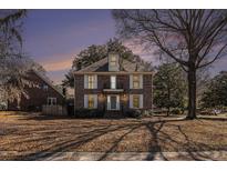 Charming two-story brick home with a balcony and mature trees on a neatly kept lawn at 24 N Basilica Ave, Hanahan, SC 29410