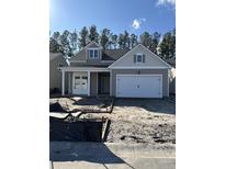Charming single-Gathering home with a two-car garage and welcoming front porch in a residential neighborhood at 586 Marsh Cove Cir, Summerville, SC 29486