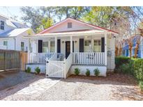 Charming single-story home with a cozy front porch and a well-maintained, landscaped yard at 721 Royall Ave, Mount Pleasant, SC 29464