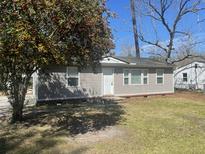Charming single-story home featuring a well-maintained lawn and mature tree at 105 Dalton Ave, North Charleston, SC 29420