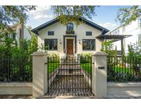 Charming two-story home with a brick pathway, iron gate, and lush green lawn at 111 S Battery St, Charleston, SC 29401