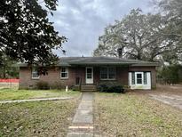 Charming brick home featuring a front porch, classic design, and inviting curb appeal at 113 Germantown Rd, Summerville, SC 29483