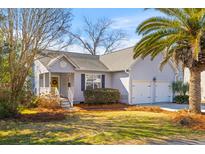 Charming single-story home with a welcoming front porch, attached two car garage and beautiful mature landscaping at 1236 Lakefront Dr, Charleston, SC 29412