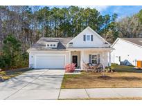 Charming one-story home with a well-manicured lawn and a welcoming front porch at 1601 Thin Pine Dr, Johns Island, SC 29455