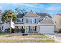 Charming two-story home with a well-manicured lawn and a welcoming front porch at 218 Mayfield Dr, Goose Creek, SC 29445