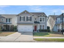 Charming two-story home with gray siding, black shutters, a red door, and a two-car garage at 231 Laurel Crest Way, Summerville, SC 29486