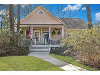 Charming traditional home featuring a welcoming front porch and well-manicured landscaping at 3009 Macbeth Creek Dr, Charleston, SC 29414