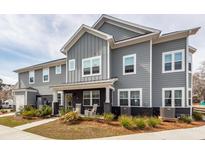 Charming two-story home with gray siding, black brick accents, inviting front porch, and well-maintained landscaping at 305 Flowering Peach Ct # 202, Charleston, SC 29414