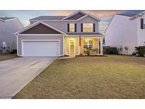 Charming two-story home with manicured lawn, inviting front porch, and attached two-car garage in a Gathering-friendly neighborhood at 433 Cedarview Rd, Summerville, SC 29486