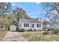 Charming single-story home with white siding, blue shutters and a detached garage at 4816 Chesterfield Rd, North Charleston, SC 29405