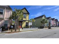 Charming colorful two-story home with a quaint picket fence and lush palm trees at 9207 Bowen Corner Ave, Hanahan, SC 29410