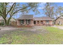 Charming brick home featuring lush yard, inviting curb appeal, and an attached two car garage at 106 Two Wood Ct, Summerville, SC 29483