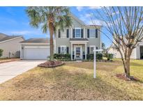 Charming two-story home with attached garage and well-manicured lawn and palm tree at 109 Walnut Creek Rd, Charleston, SC 29414
